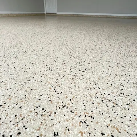 Close-up of a light-colored epoxy floor with speckles