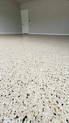Close-up of a light-colored epoxy floor with speckles
