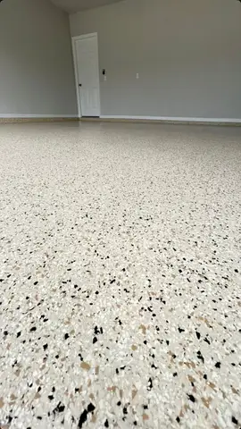 Close-up of a light-colored epoxy floor with speckles